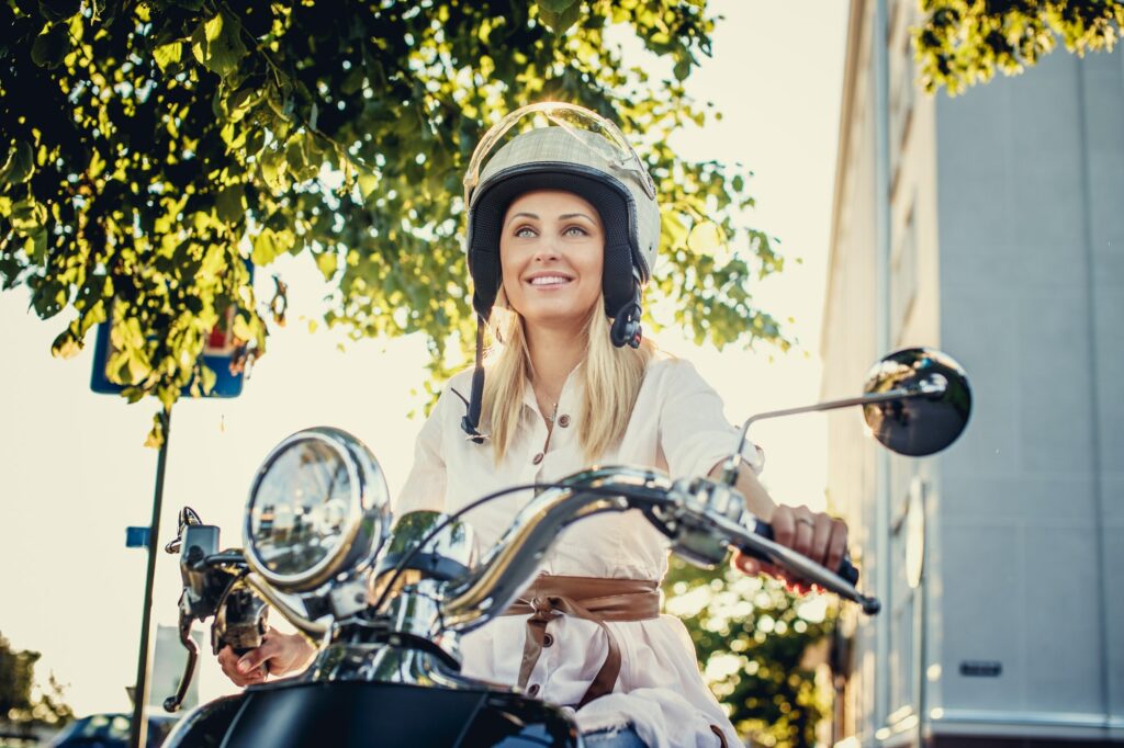 Smiling blond girl in moto helme