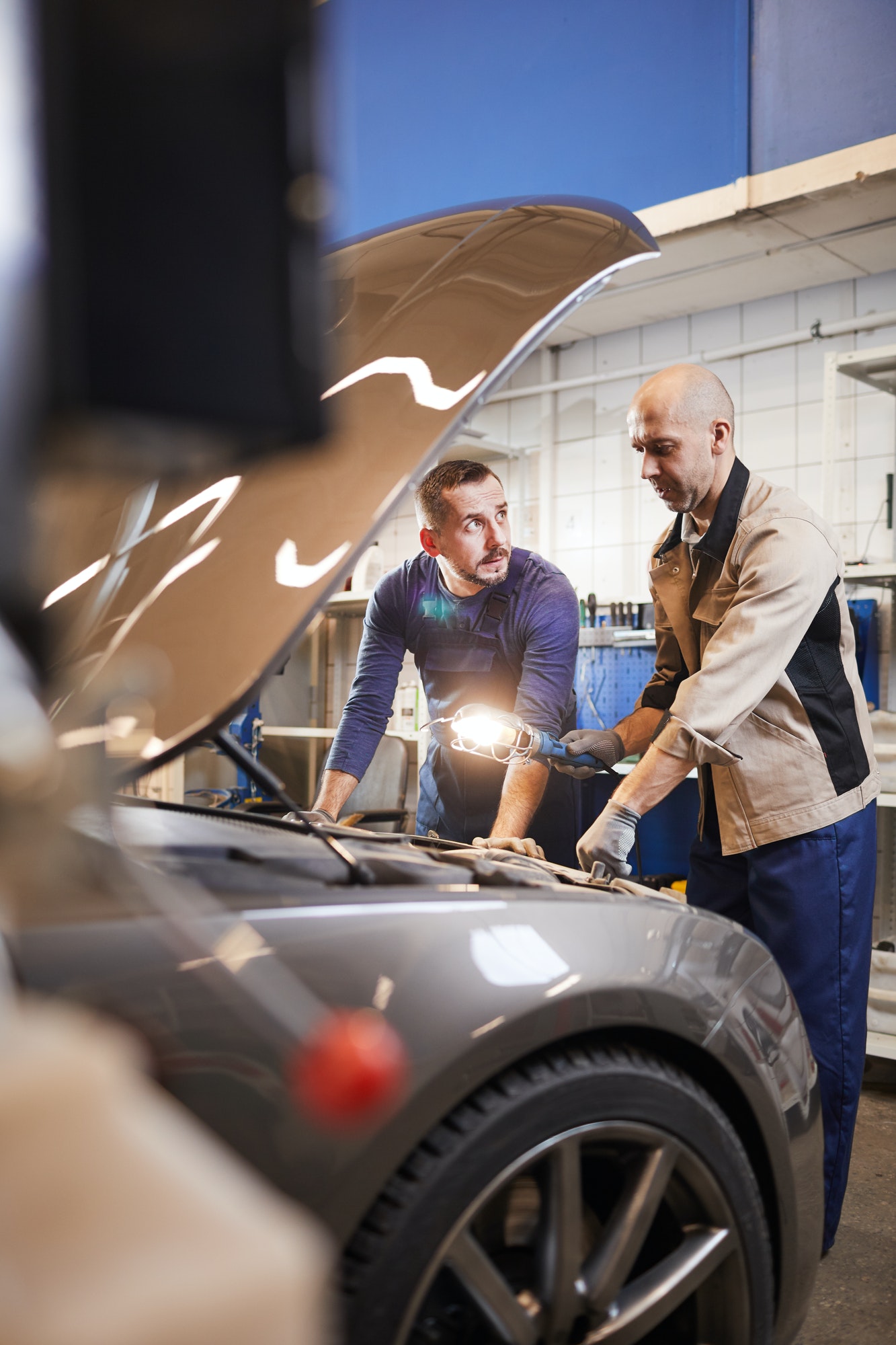 Workers Inspecting Car in Auto Shop